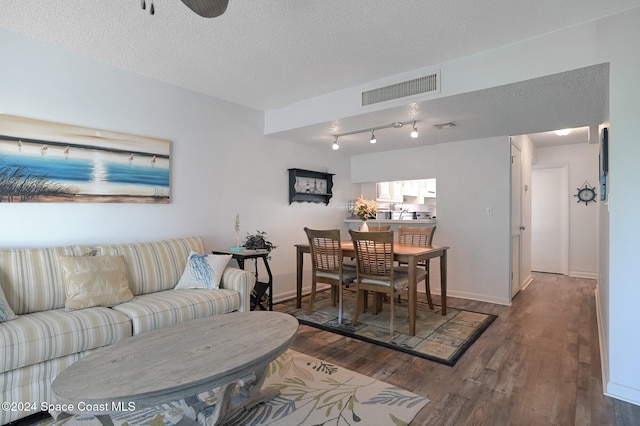 living room featuring a textured ceiling and hardwood / wood-style flooring