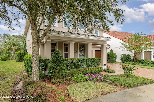 mediterranean / spanish-style home with a garage