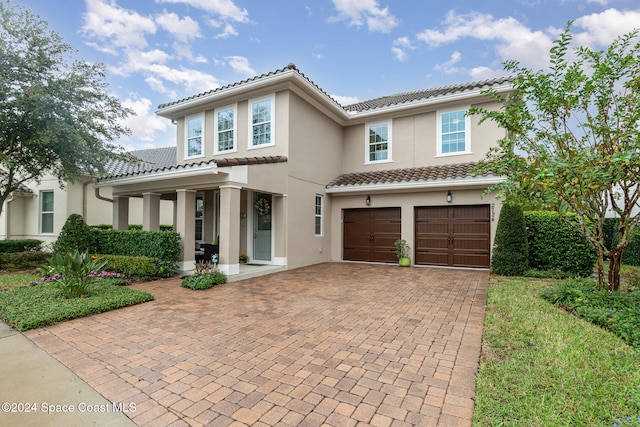 mediterranean / spanish-style home with a garage