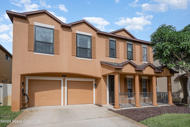 multi unit property featuring a garage and a porch