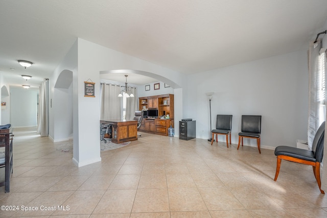 living room with a notable chandelier and light tile patterned floors