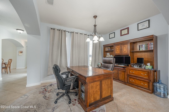 tiled home office featuring a chandelier and built in desk