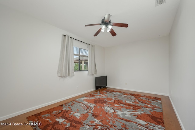 empty room featuring hardwood / wood-style floors and ceiling fan