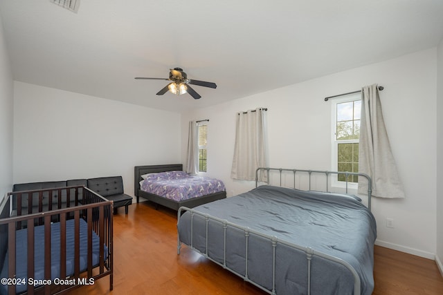 bedroom with hardwood / wood-style floors and ceiling fan