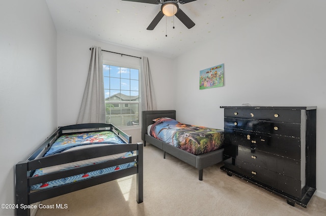 bedroom with ceiling fan and light carpet