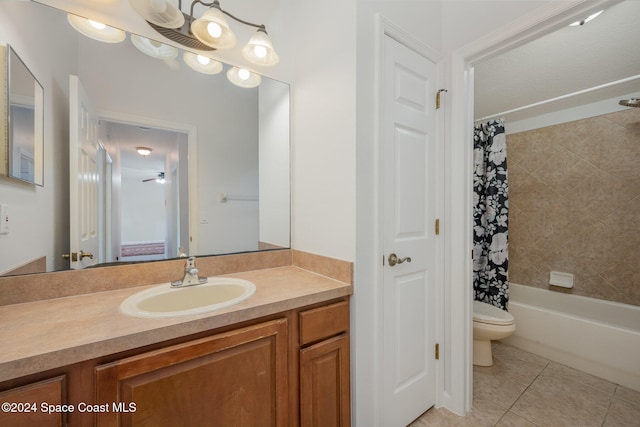 full bathroom featuring toilet, vanity, shower / bath combo with shower curtain, and tile patterned floors