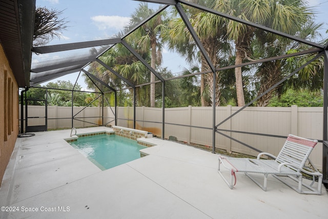 view of pool with a patio area and a lanai