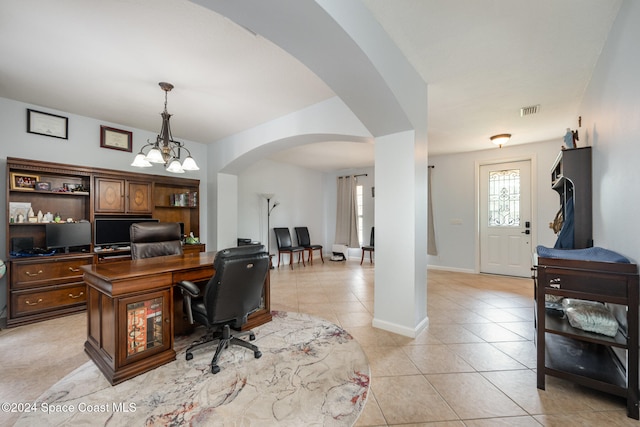 home office with an inviting chandelier and light tile patterned floors