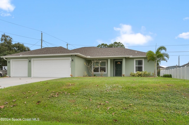 single story home featuring a garage and a front lawn