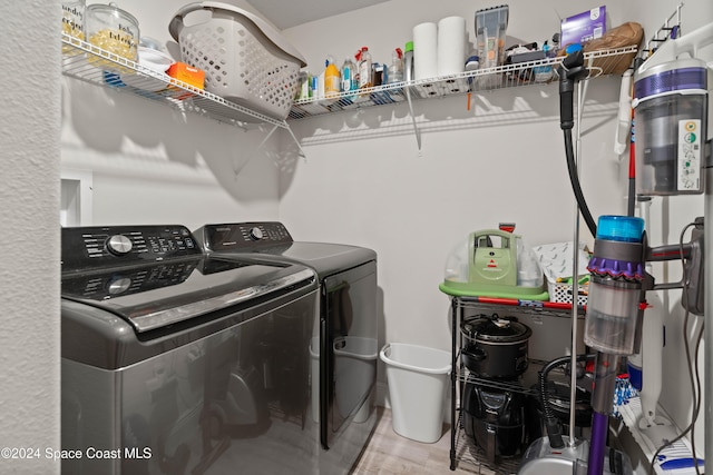 washroom with washing machine and dryer and wood-type flooring