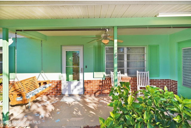 view of patio featuring ceiling fan and a porch