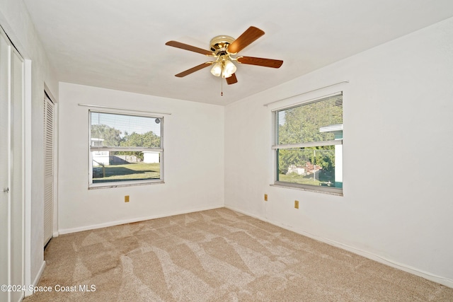 unfurnished bedroom with ceiling fan and light carpet