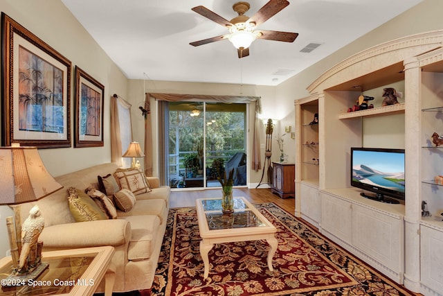 living room featuring wood-type flooring and ceiling fan