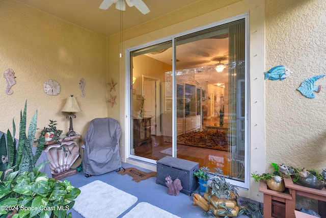 entrance to property with ceiling fan