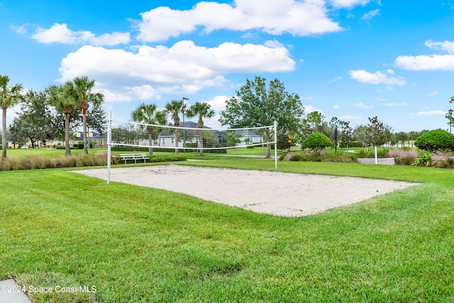 view of home's community featuring a lawn and volleyball court