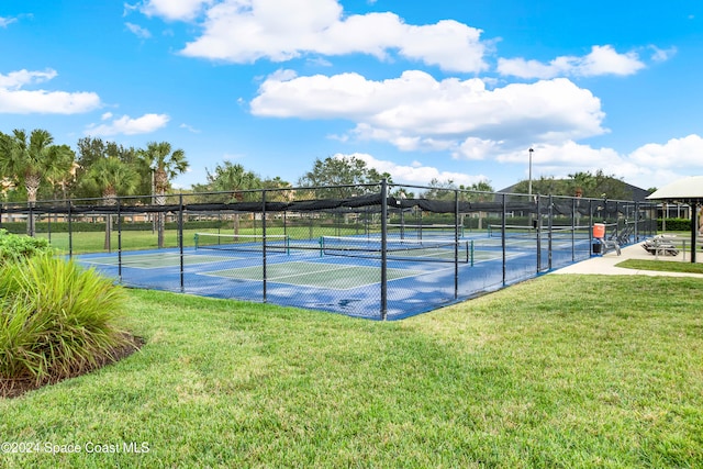 view of tennis court with a lawn