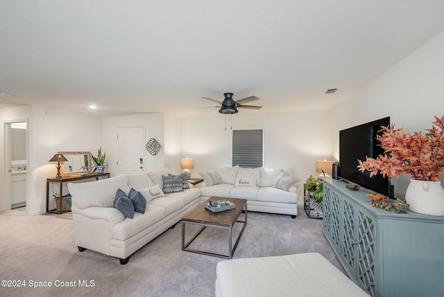 living room with ceiling fan and light colored carpet