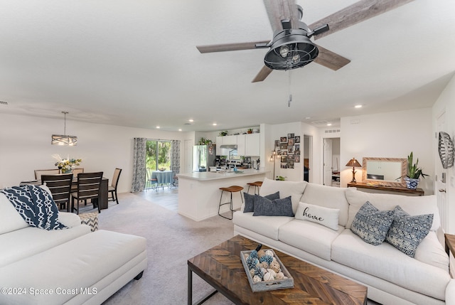 carpeted living room featuring ceiling fan