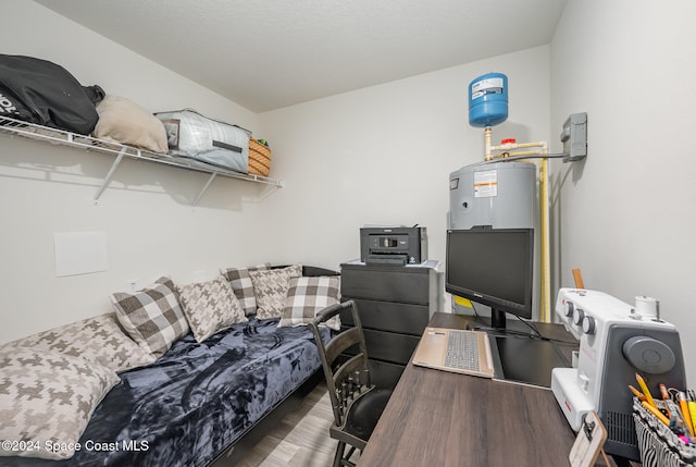 office featuring dark wood-type flooring and water heater