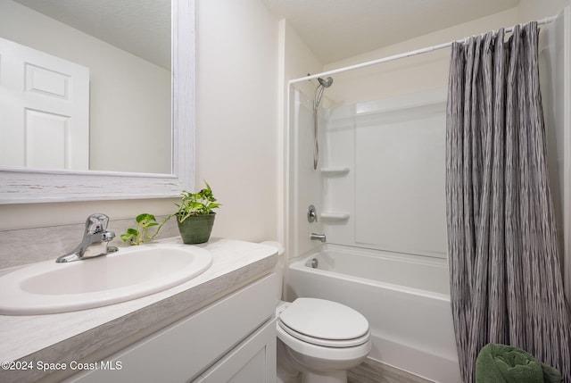 full bathroom featuring shower / bath combo, vanity, and toilet