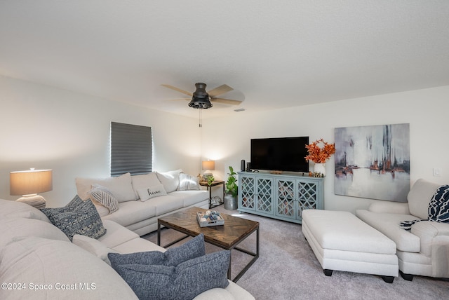 carpeted living room with ceiling fan