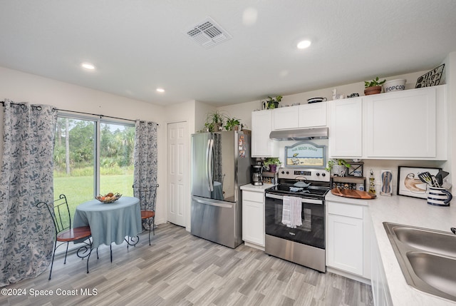 kitchen featuring light hardwood / wood-style flooring, white cabinetry, sink, and stainless steel appliances