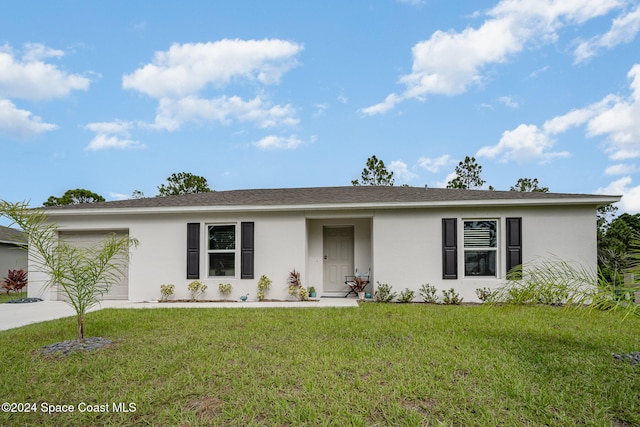 ranch-style house with a garage and a front lawn