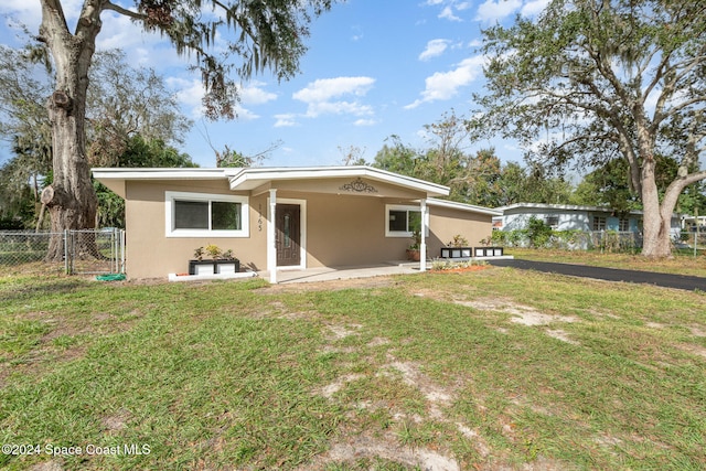 rear view of property with a lawn