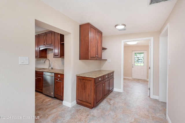 kitchen with a textured ceiling, dishwasher, and sink