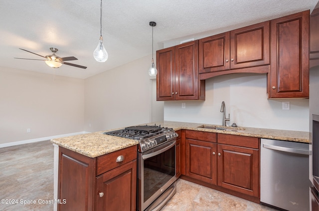 kitchen featuring hanging light fixtures, sink, ceiling fan, a textured ceiling, and appliances with stainless steel finishes