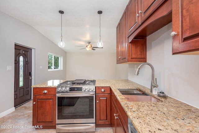 kitchen with light stone counters, stainless steel gas range oven, vaulted ceiling, ceiling fan, and sink