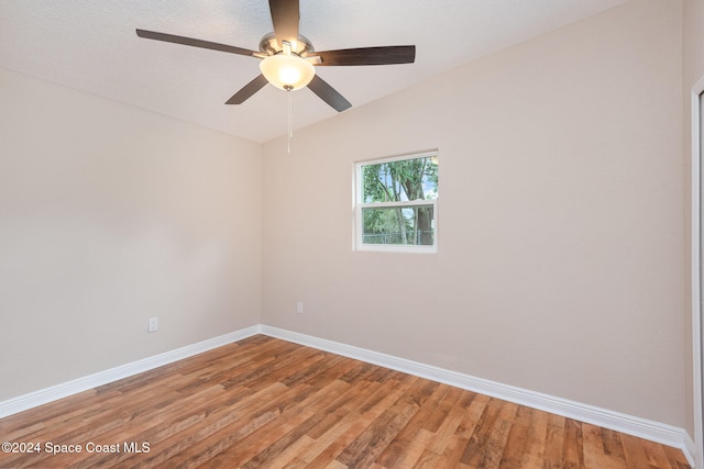 unfurnished room with hardwood / wood-style flooring, ceiling fan, and lofted ceiling