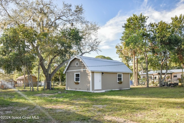 view of outdoor structure featuring a lawn