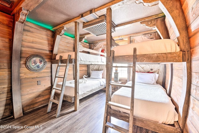 unfurnished bedroom with wood-type flooring and a textured ceiling