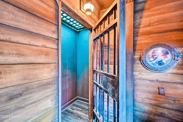 interior details featuring wooden walls and hardwood / wood-style flooring