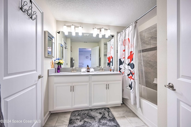 bathroom with a textured ceiling, vanity, shower / bath combo with shower curtain, and tile patterned floors