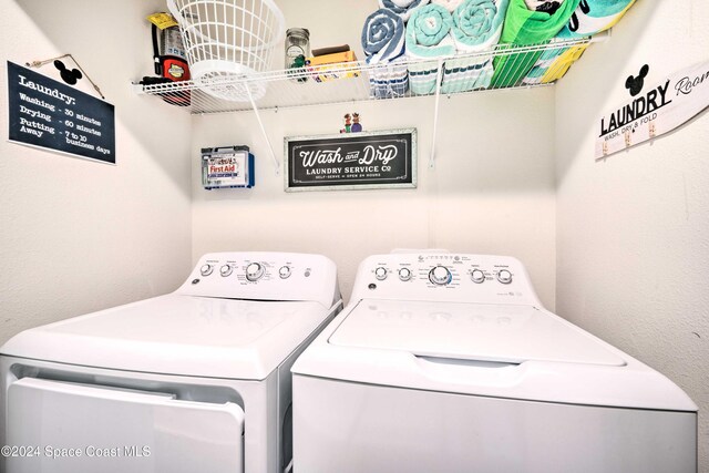 clothes washing area with washing machine and clothes dryer