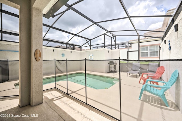 view of pool with a lanai and a patio