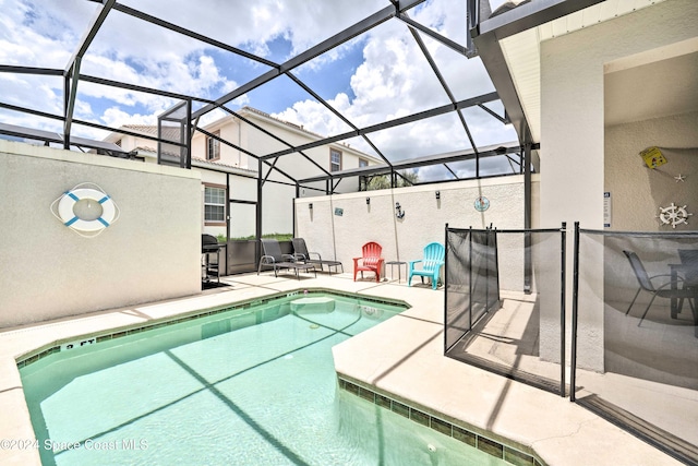 view of swimming pool with a lanai and a patio area