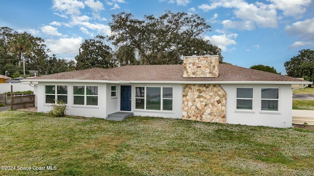 3109 Indian River Dr, Cocoa, FL 32922 - back of property featuring stone siding, stucco siding, a chimney, and roof with shingles