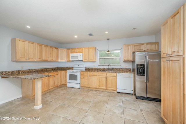 kitchen with light brown cabinets, light tile patterned flooring, hanging light fixtures, and white appliances