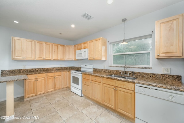 kitchen featuring light brown cabinetry, sink, decorative light fixtures, and white appliances