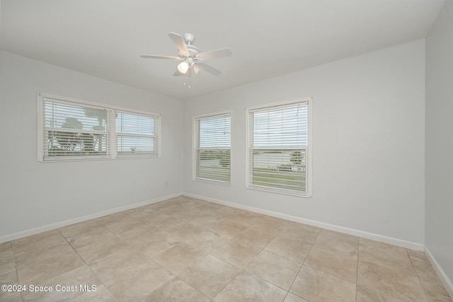3109 Indian River Dr, Cocoa, FL 32922 - empty room with ceiling fan, baseboards, and light tile patterned floors