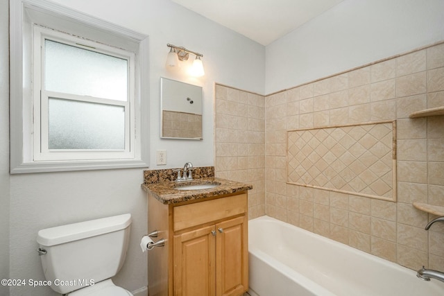 full bathroom featuring vanity, toilet, and tiled shower / bath combo