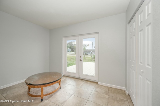 doorway to outside featuring french doors and light tile patterned flooring