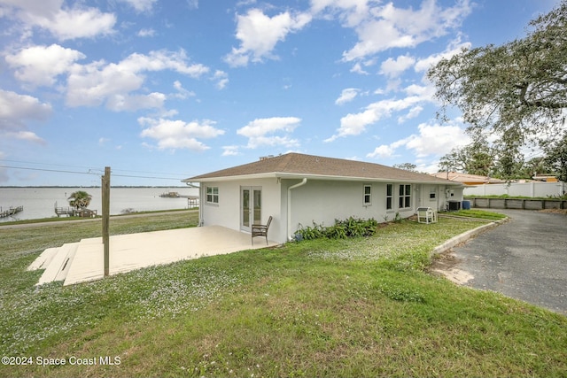 3109 Indian River Dr, Cocoa, FL 32922 - rear view of property with french doors, stucco siding, a patio area, and a water view
