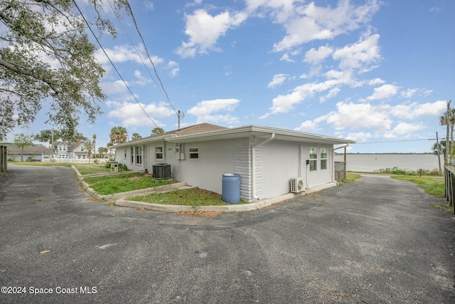 3109 Indian River Dr, Cocoa, FL 32922 - view of side of property featuring cooling unit and stucco siding