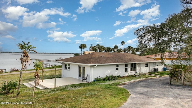 3109 Indian River Dr, Cocoa, FL 32922 - rear view of property with stucco siding, a patio area, cooling unit, french doors, and a water view