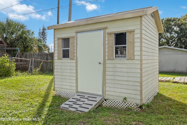 view of outbuilding with a yard