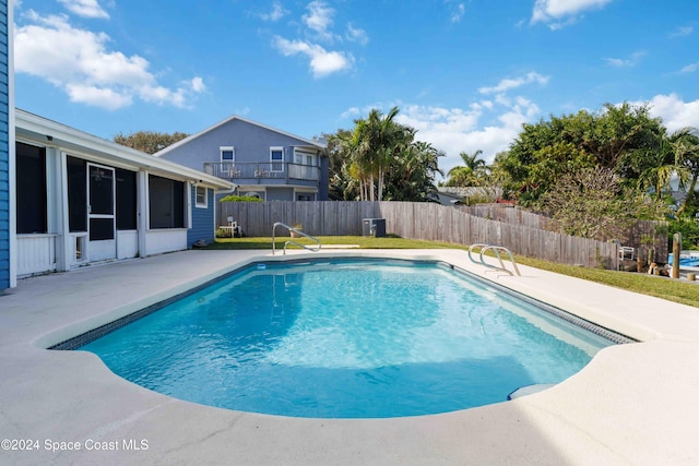 view of pool featuring central air condition unit, a yard, and a patio area